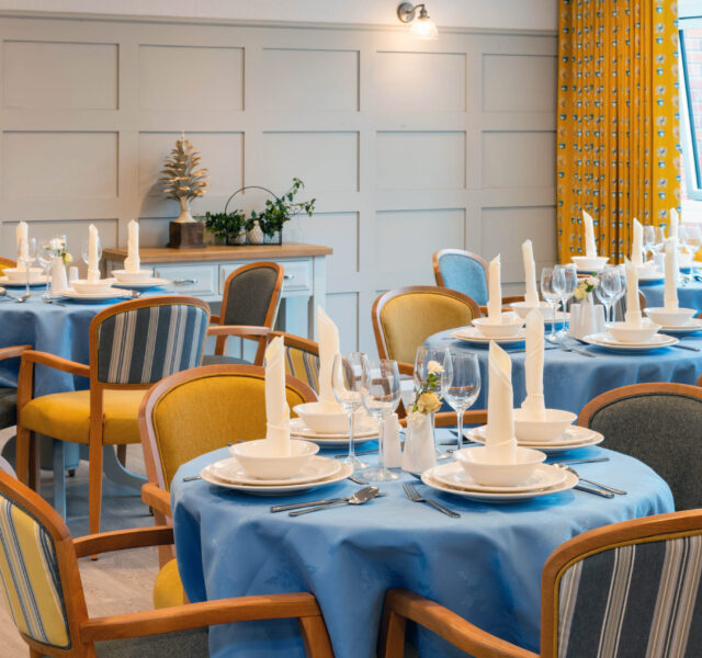 A dining room with beautifully laid tables