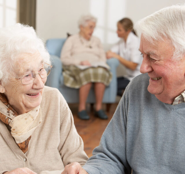 An elderly man and woman chatting and laughing